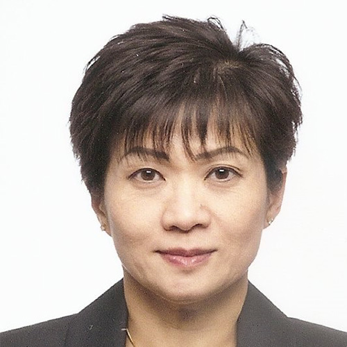 Headshot of National Nuclear Security Administration speaker Thuc Hoang. She smiles and wears a dark gray blazer. She stands in front of a white backdrop.